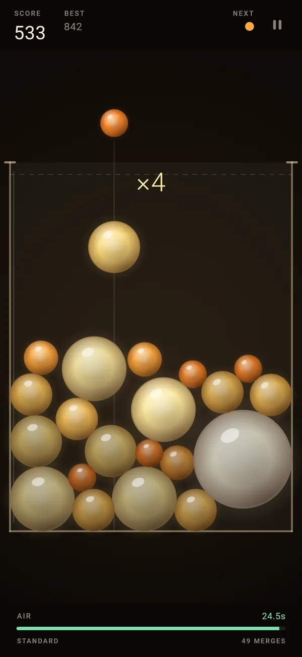 Early in a run: a wide jar, a loose pile of amber and gold orbs, a times-four chain showing in the jar, and a full green AIR bar at 24.5 seconds.