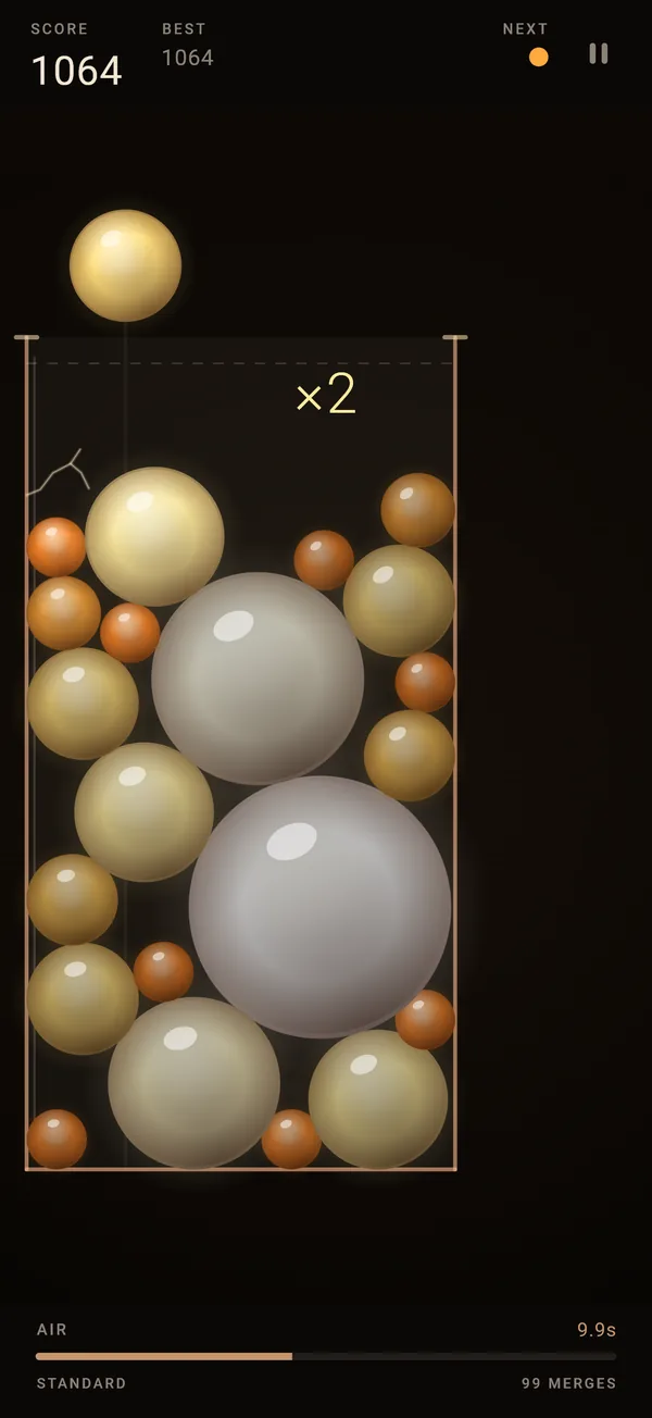 A jar late in a run: the walls have closed well inside the rim, the pile is packed with big pearl orbs, and the AIR bar is down to 9.9 seconds.